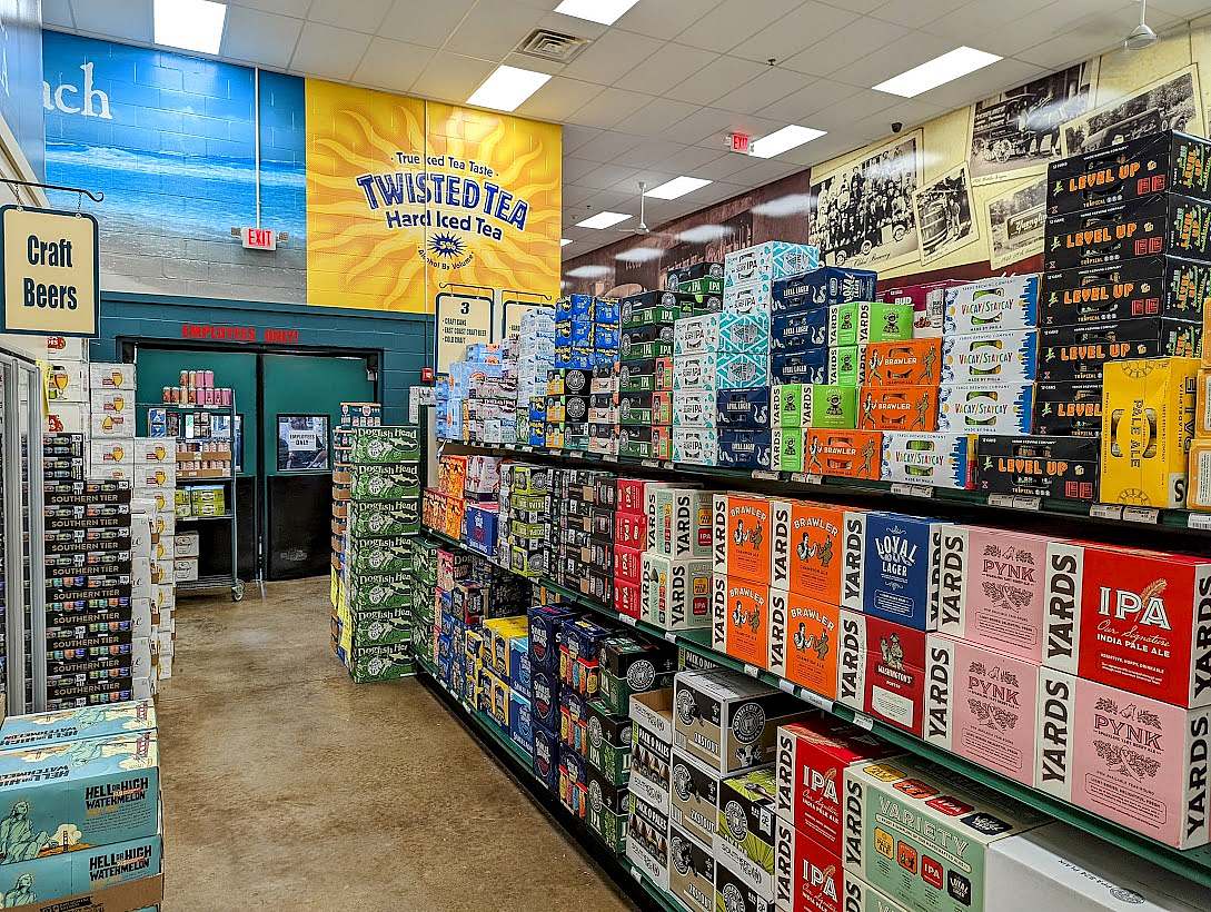A store with shelves full of beer bottles and cans.