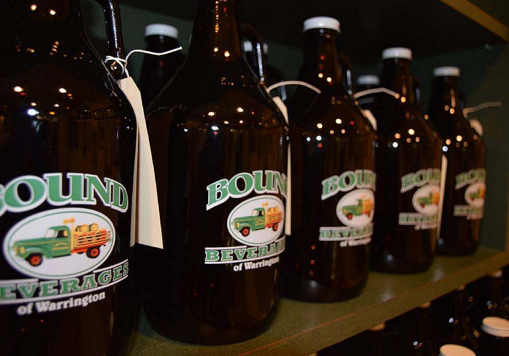A row of beer bottles on a shelf.