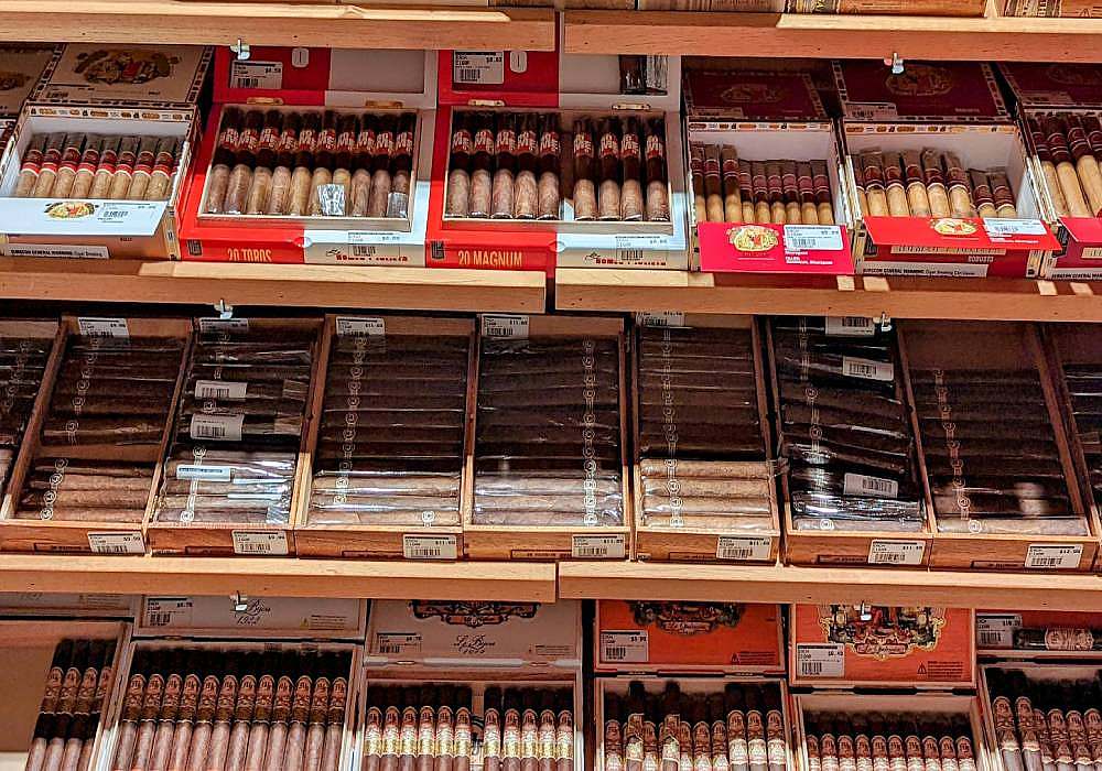 Cigars on shelves in a store.